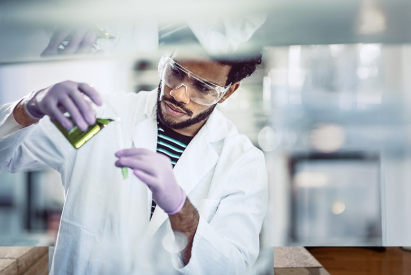 Scientist in lab analyzing samples.